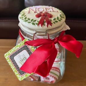 Christmas canister NWT. Top wording NOEL top of canister is ceramic.
